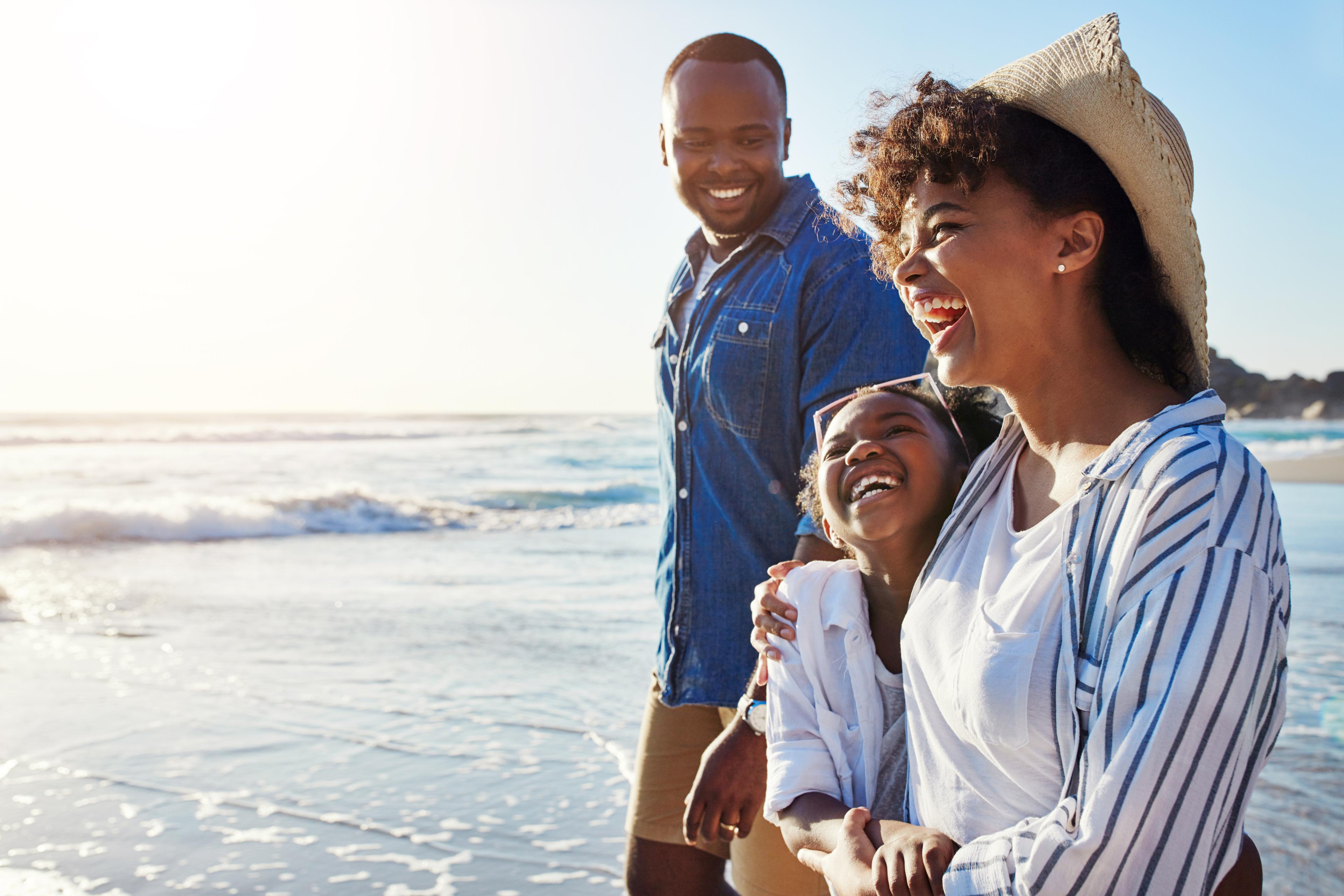 Family smiling on the beach